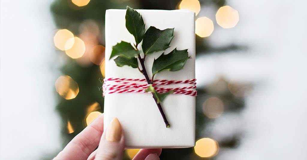 Image of wrapped Christmas present with holly on it